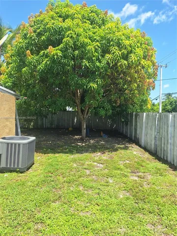 a view of a backyard with large trees
