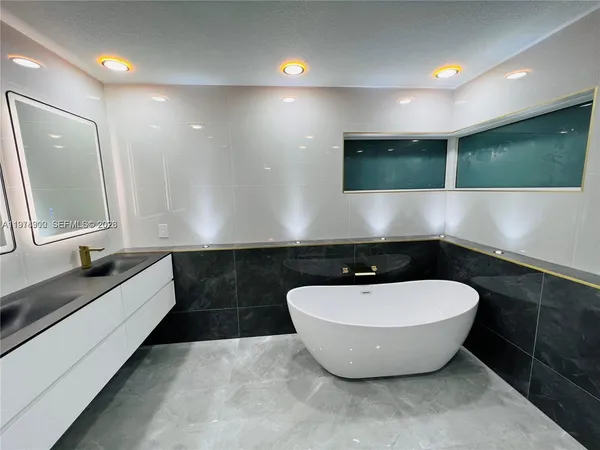 a bathroom with a bathtub and a sink