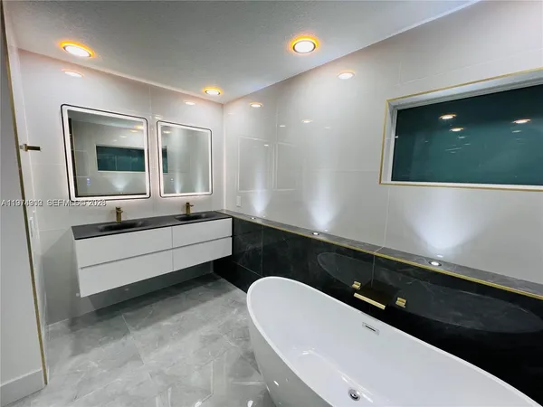 a bathroom with a double vanity sink and mirror