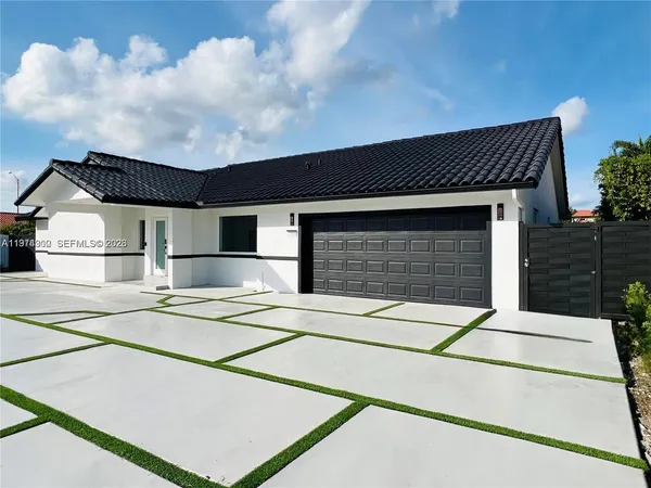 a front view of a house with garage