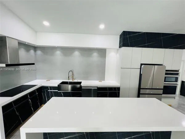 a kitchen with a sink and a refrigerator