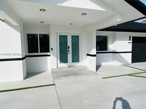 a view of a kitchen with a sink and a refrigerator