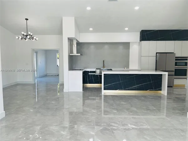 a view of kitchen with stainless steel appliances a refrigerator and a cabinets