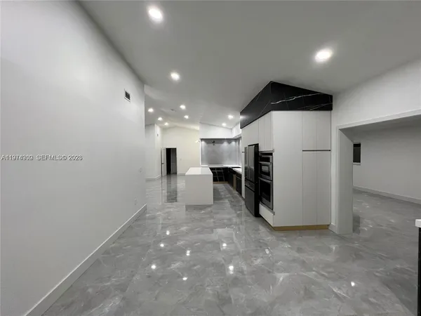 a view of a refrigerator in kitchen and a room