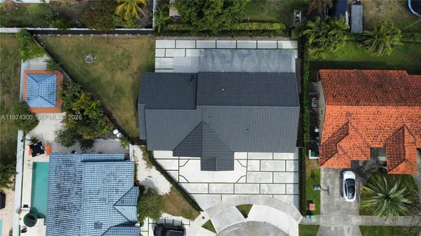 an aerial view of a house with a yard
