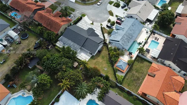 an aerial view of a house with garden space and street view