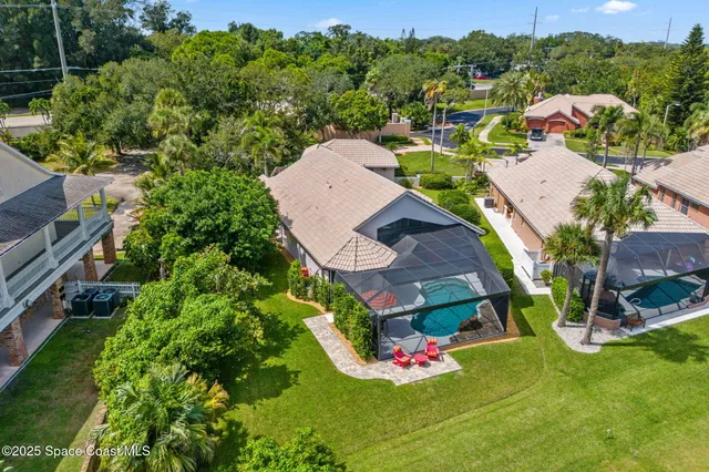 an aerial view of a house with garden space and street view