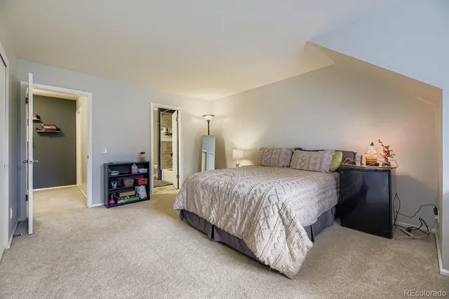 a spacious bedroom with a bed and a couch