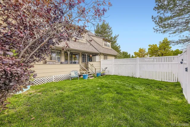 a view of a house with backyard and sitting area
