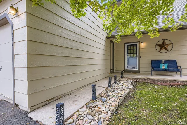 a view of house with backyard and wooden fence