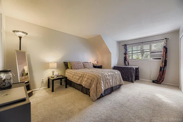 a spacious bedroom with a bed and furniture