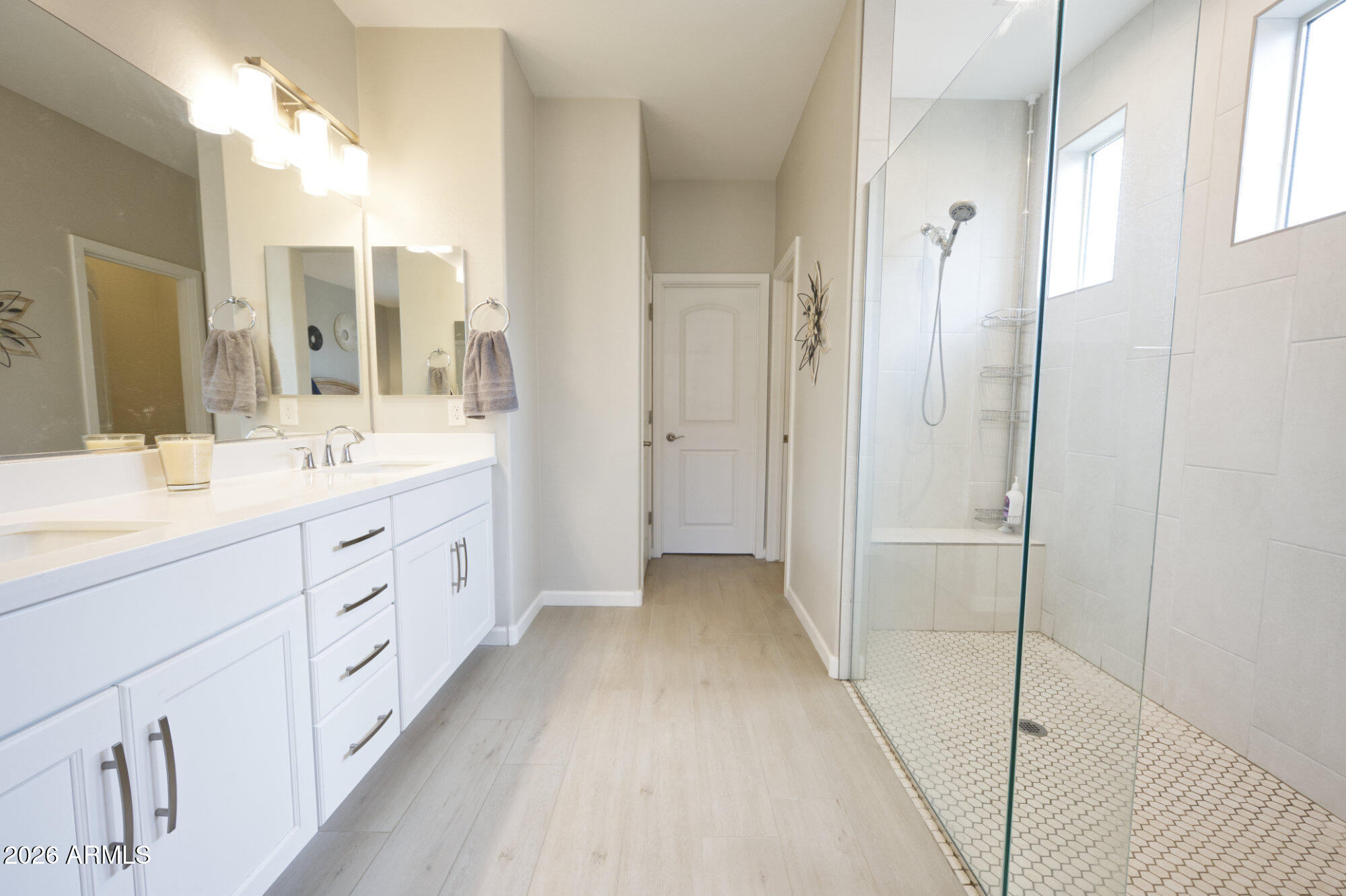 576 Whistle Stop Road Clarkdale, AZ 86324 - Photo 13 of 28 a spacious bathroom with a double vanity sink a mirror and a shower