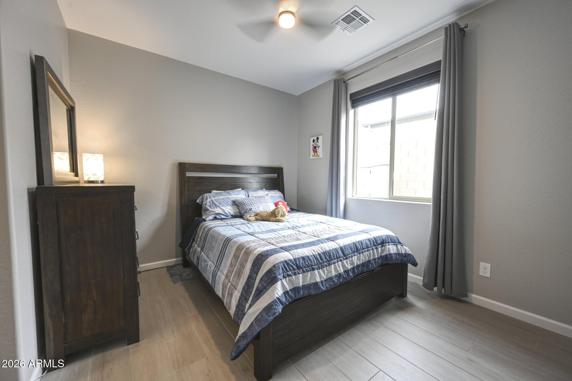 576 Whistle Stop Road Clarkdale, AZ 86324 - Photo 17 of 28 a bed sitting in a bedroom next to a window