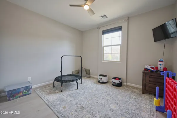 a view of a workspace with furniture and a window