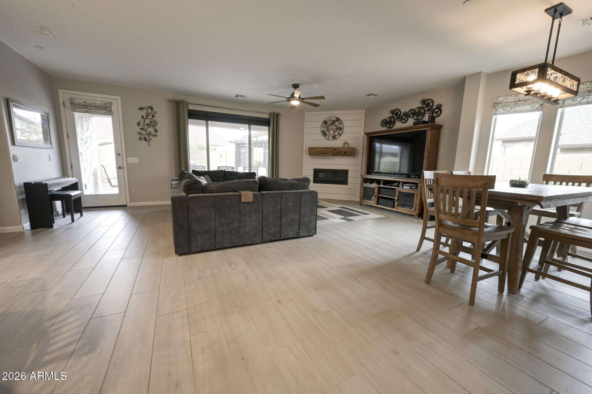 576 Whistle Stop Road Clarkdale, AZ 86324 - Photo 4 of 28 a living room with furniture a fireplace and a chandelier