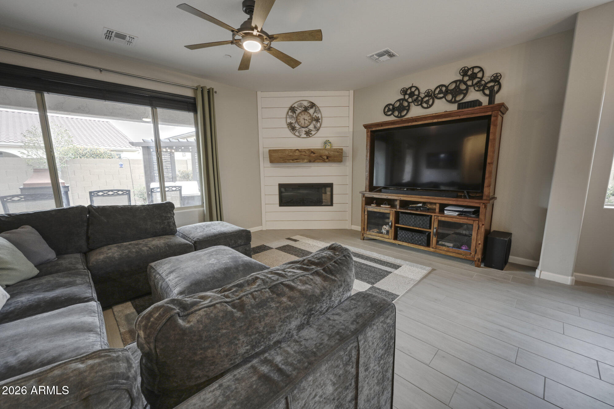 576 Whistle Stop Road Clarkdale, AZ 86324 - Photo 5 of 28 a living room with furniture a flat screen tv and a fireplace