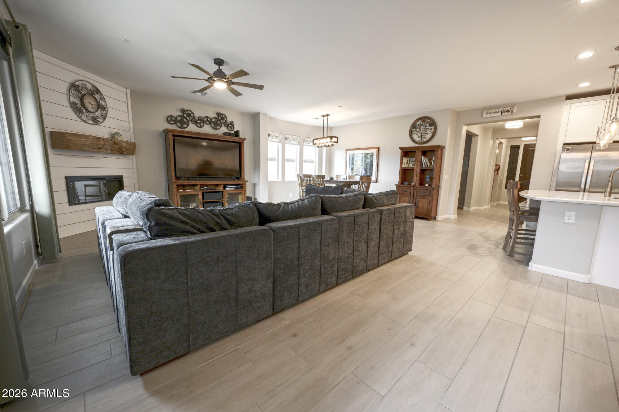 576 Whistle Stop Road Clarkdale, AZ 86324 - Photo 6 of 28 a living room with furniture a fireplace and a flat screen tv