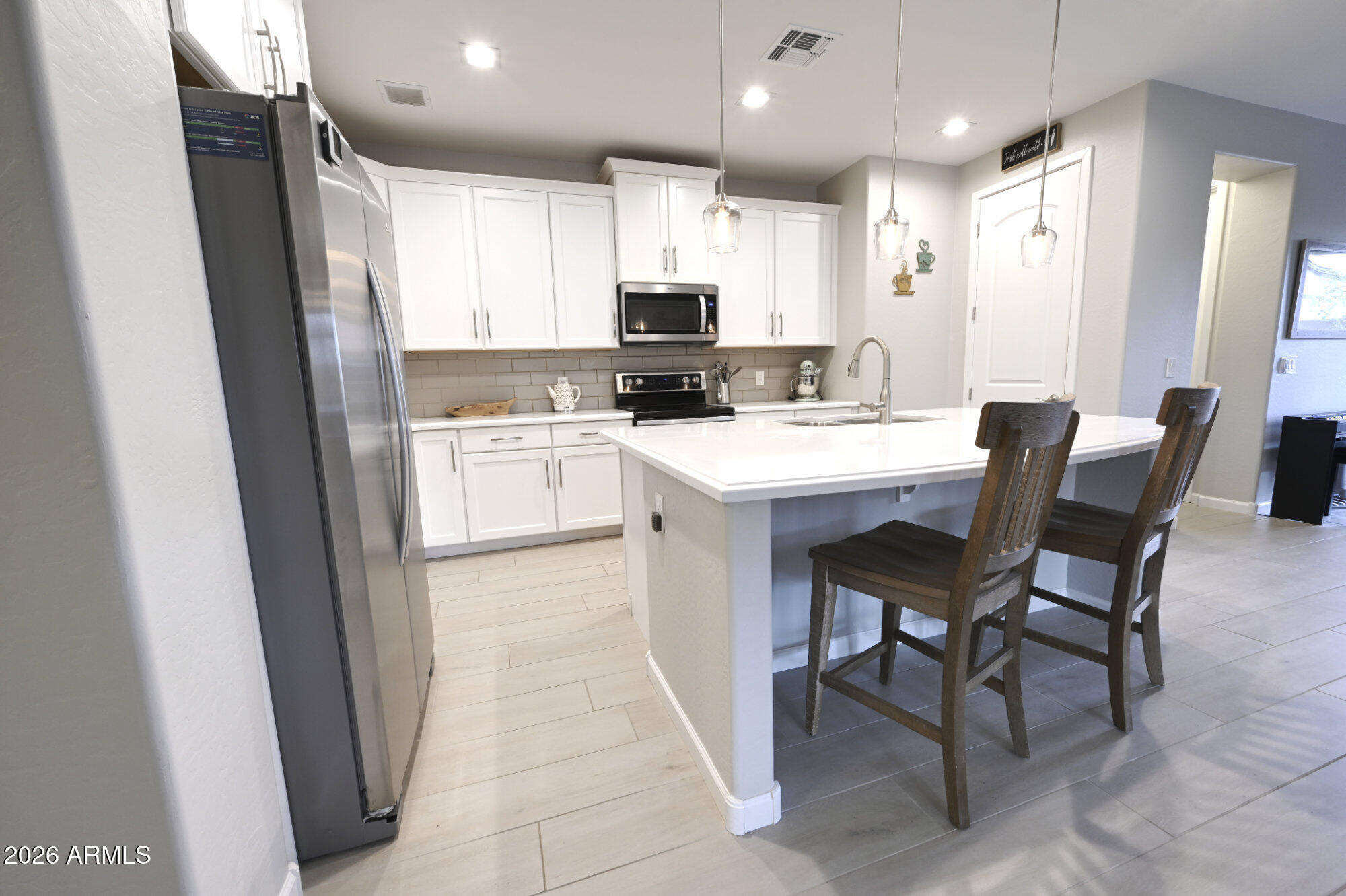 576 Whistle Stop Road Clarkdale, AZ 86324 - Photo 9 of 28 a kitchen with a sink a microwave a stove and a refrigerator
