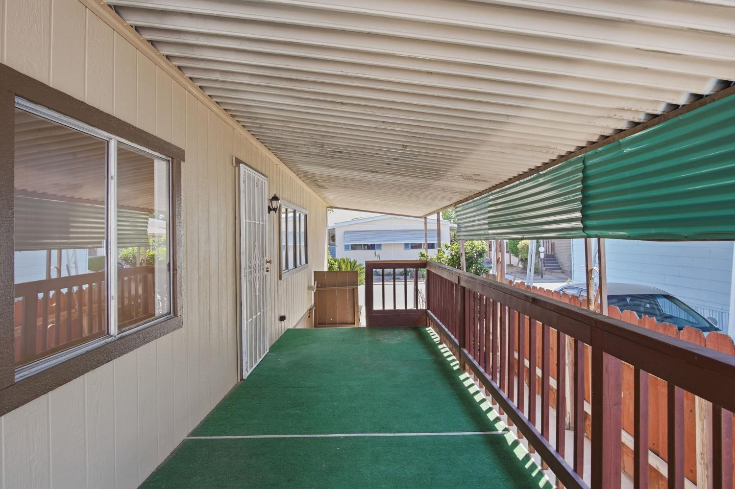 1200 South Carpenter Road, Unit 10 Modesto, CA 95351 - Photo 27 of 27 a view of a porch with wooden floor and fence