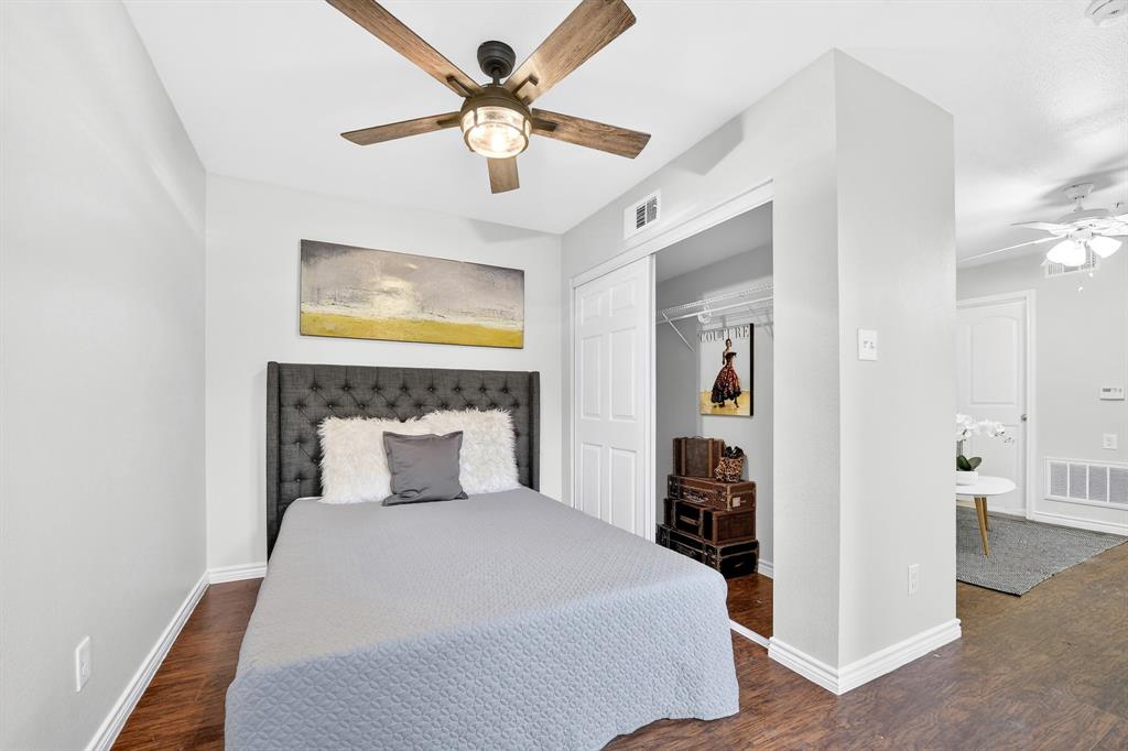 9829 Walnut Street, Unit 308 Dallas, TX 75243 - Photo 21 of 24 a bedroom with a bed and a chandelier