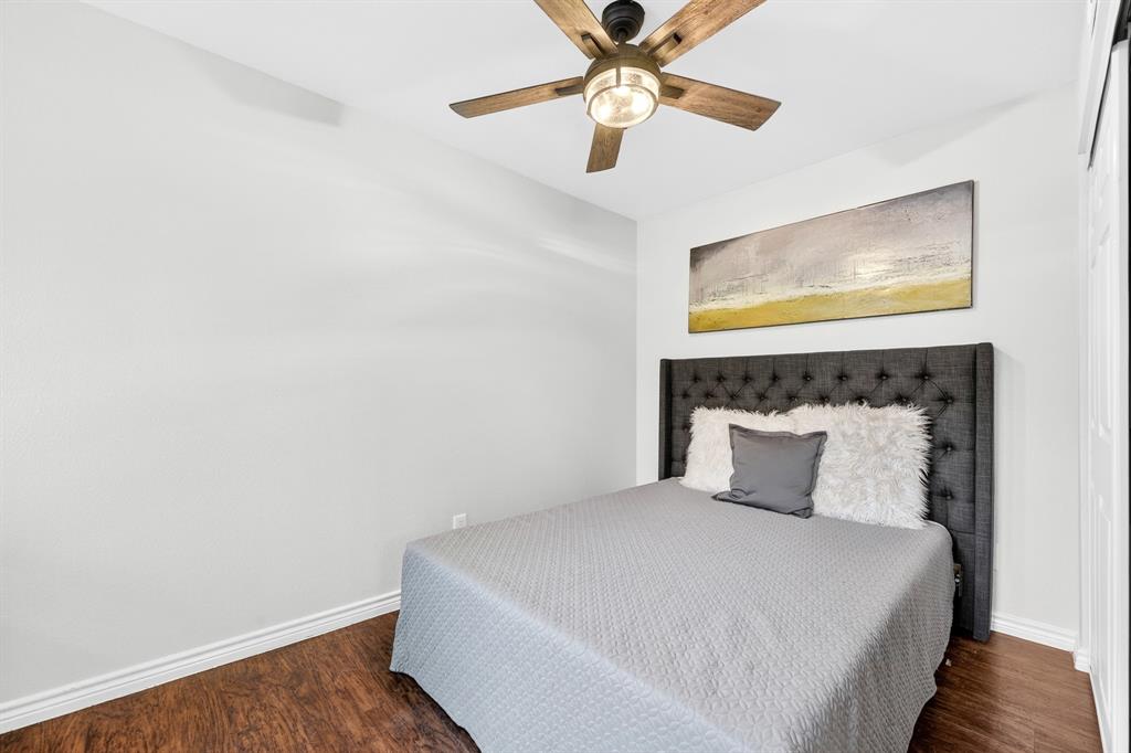 9829 Walnut Street, Unit 308 Dallas, TX 75243 - Photo 22 of 24 a bedroom with a bed and a painting on the wall