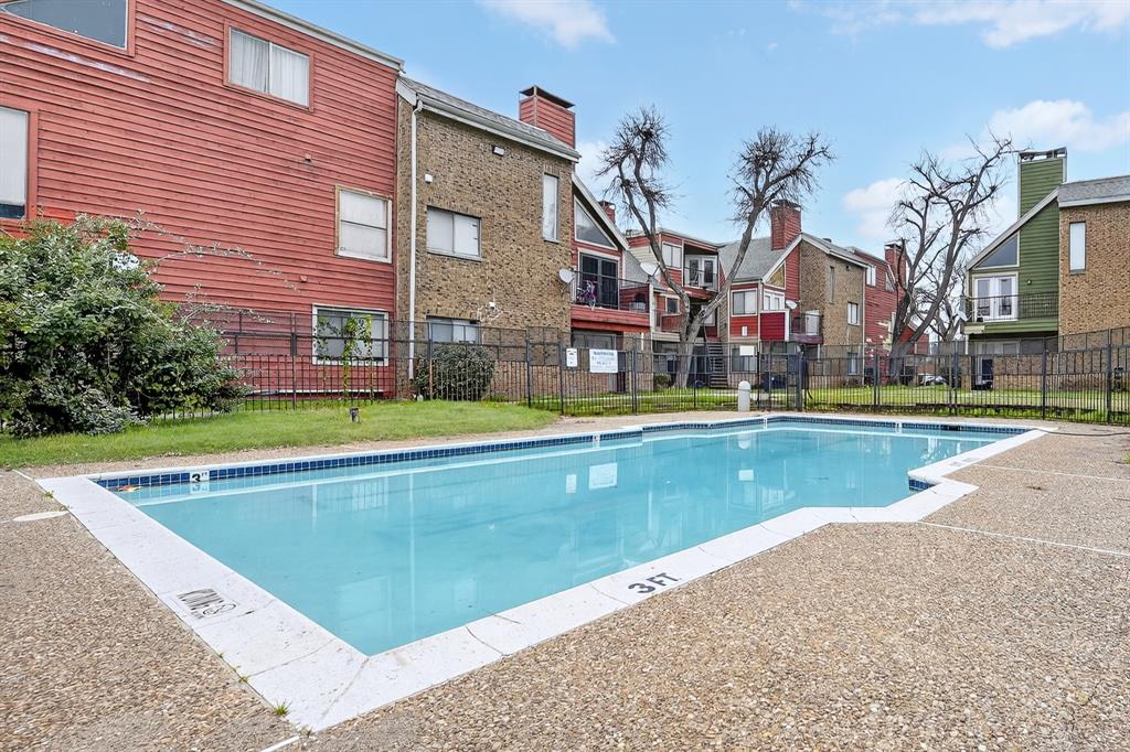 9829 Walnut Street, Unit 308 Dallas, TX 75243 - Photo 3 of 24 a view of pool with tall buildings and a big yard