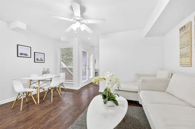 a living room with furniture dining table and a large window