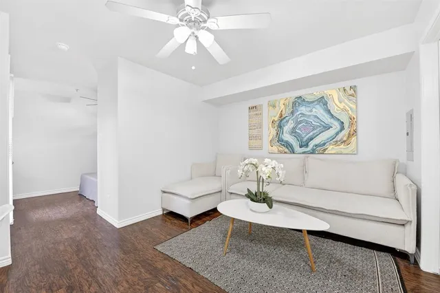 a living room with furniture and a painting on the wall