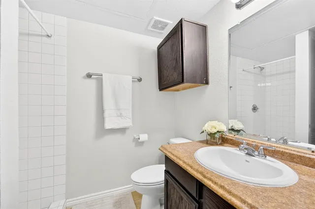 a bathroom with a sink toilet and mirror