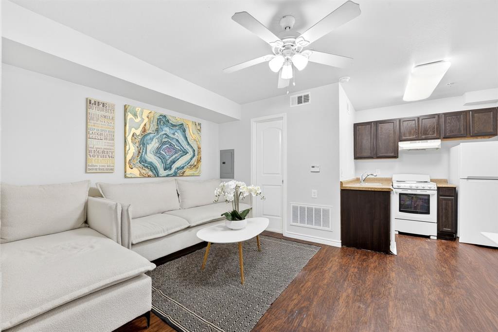 9829 Walnut Street, Unit 308 Dallas, TX 75243 - Photo 9 of 24 a living room with furniture and a kitchen