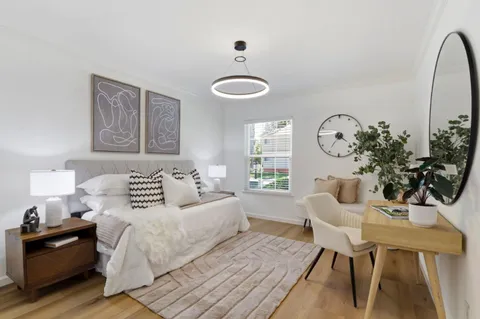 a bedroom with a bed and a chandelier