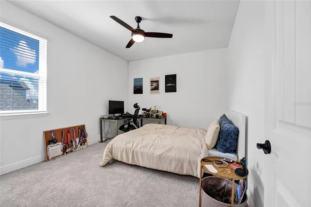 a bedroom with a bed and a window