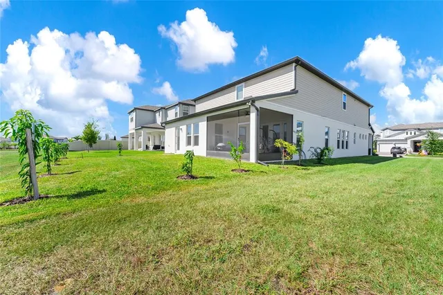 a view of a house with backyard and sitting area