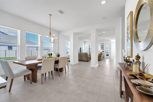 a dining room with furniture a chandelier and a rug