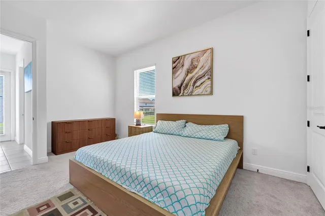 a bedroom with a bed and a wall painting