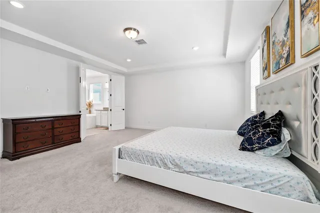 a bedroom with a bed and a dresser