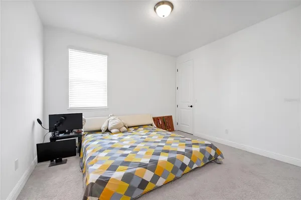 a bedroom with a bed and a tv