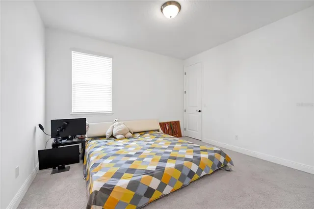 a bedroom with a bed and a tv