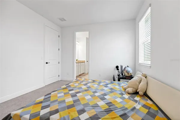 a bedroom with a bed and a window