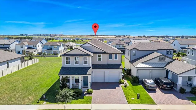 an aerial view of multiple houses with a yard