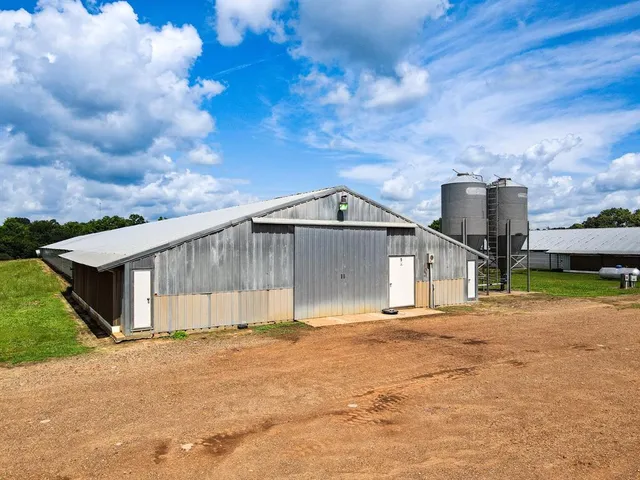 a view of a house with a yard and fence