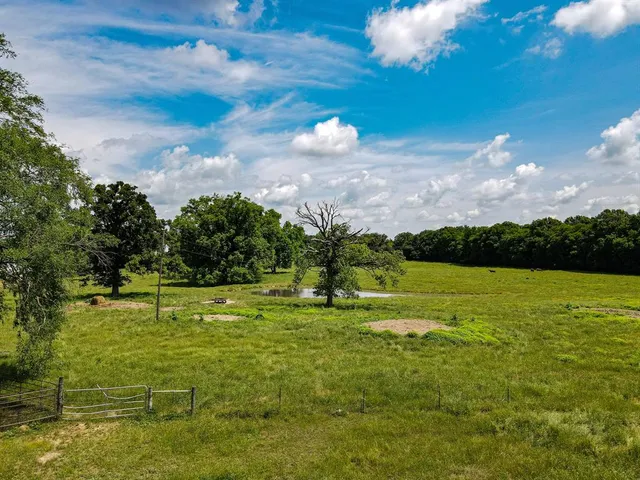 a swimming pool with trees in the background