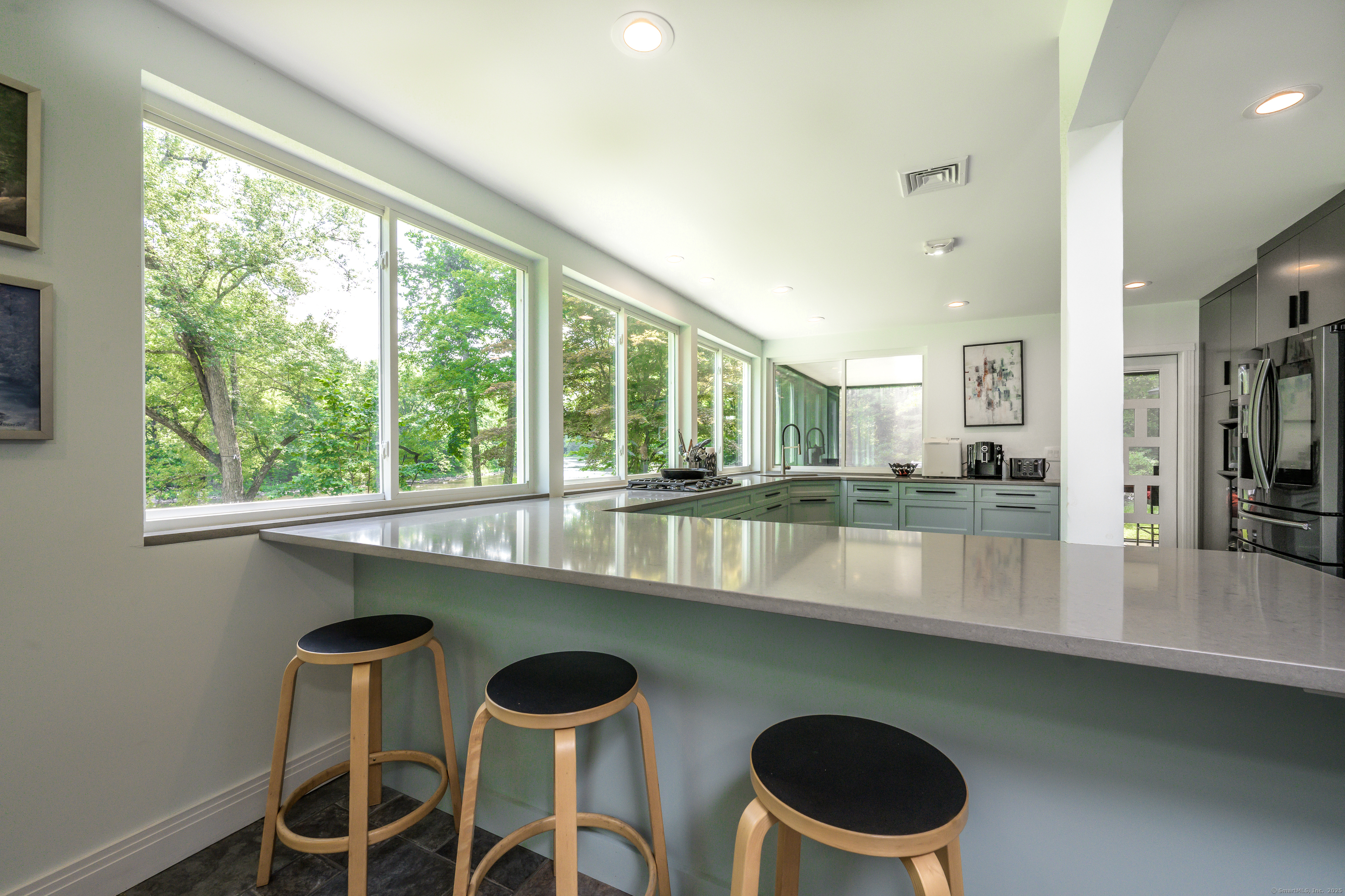 35 Kirk Road Sharon, CT 06796 - Photo 26 of 40 a kitchen with a table chairs and a wooden floor