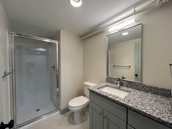 a bathroom with a glass shower door