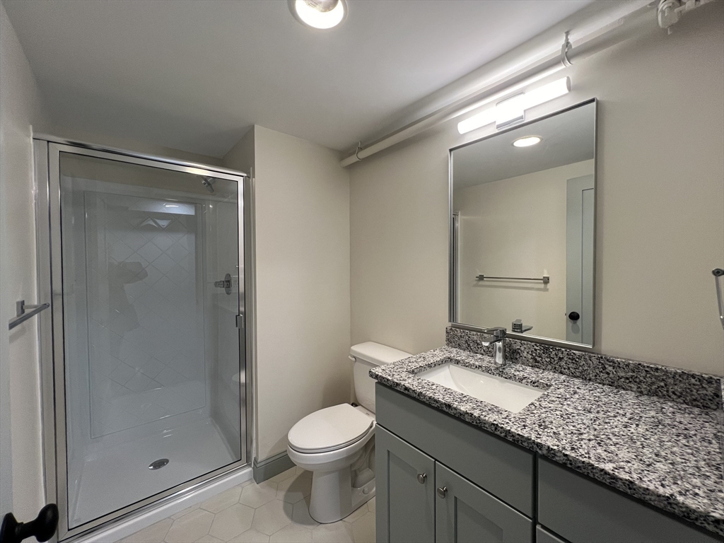 160 Seabury Street, Unit 28 Fall River, MA 02720 - Photo 8 of 10 a bathroom with a granite countertop sink a toilet and shower
