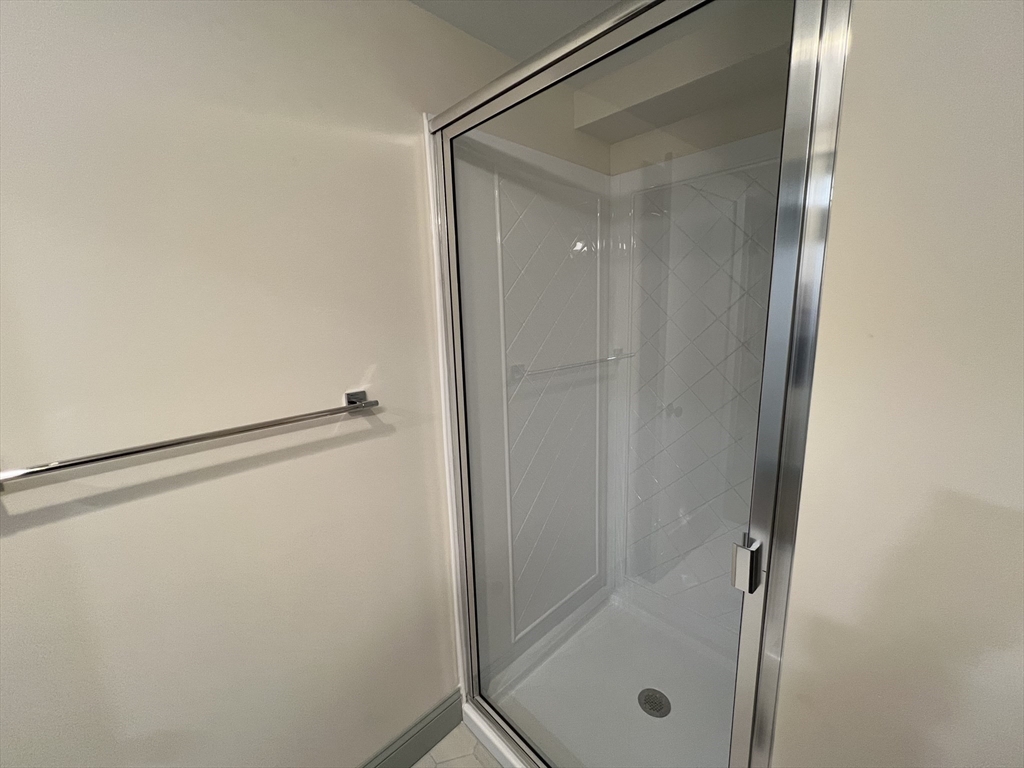 160 Seabury Street, Unit 28 Fall River, MA 02720 - Photo 9 of 10 a bathroom with a glass shower door