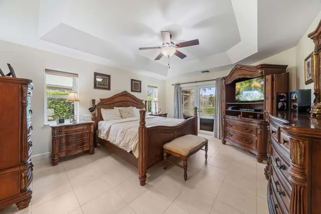 a bathroom with a granite countertop sink a mirror and shower