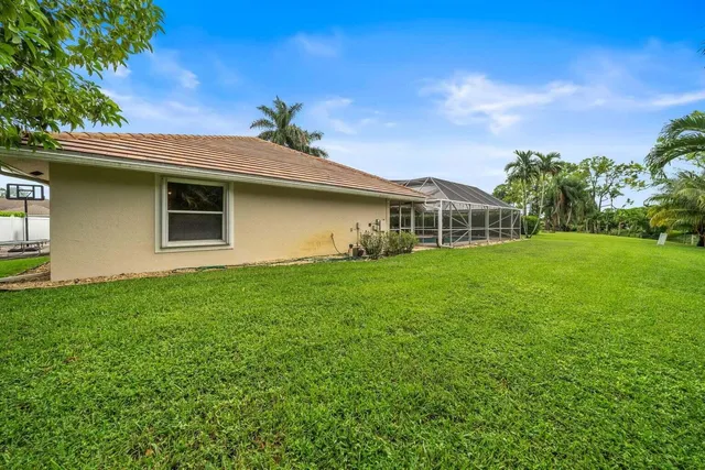 a white house that has tree in front of it