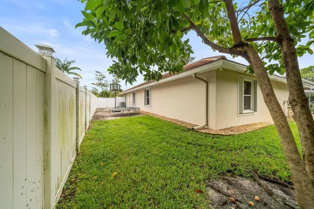 a view of a house with a yard and sitting area