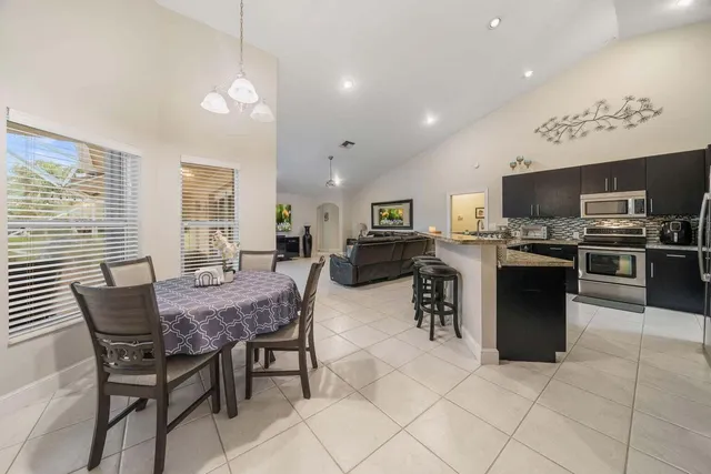 a kitchen with granite countertop a sink and a stove top oven